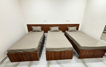 3-sharing AC room at Casavir Mens PG in Madhapur, spacious layout with wooden beds