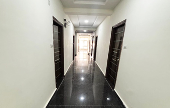 Interior hallway inside Casavir Mens PG Madhapur, dark tile flooring, room access view