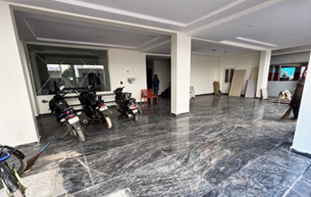 Two-wheeler parking zone at Casavir PG, ground-level common area with scooters